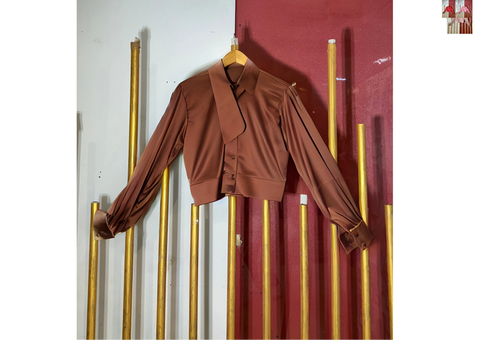 Brown blouse on a hanger against a red and white striped background