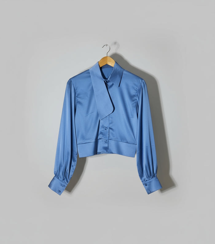 Blue shirt on a hanger against a red and gold background