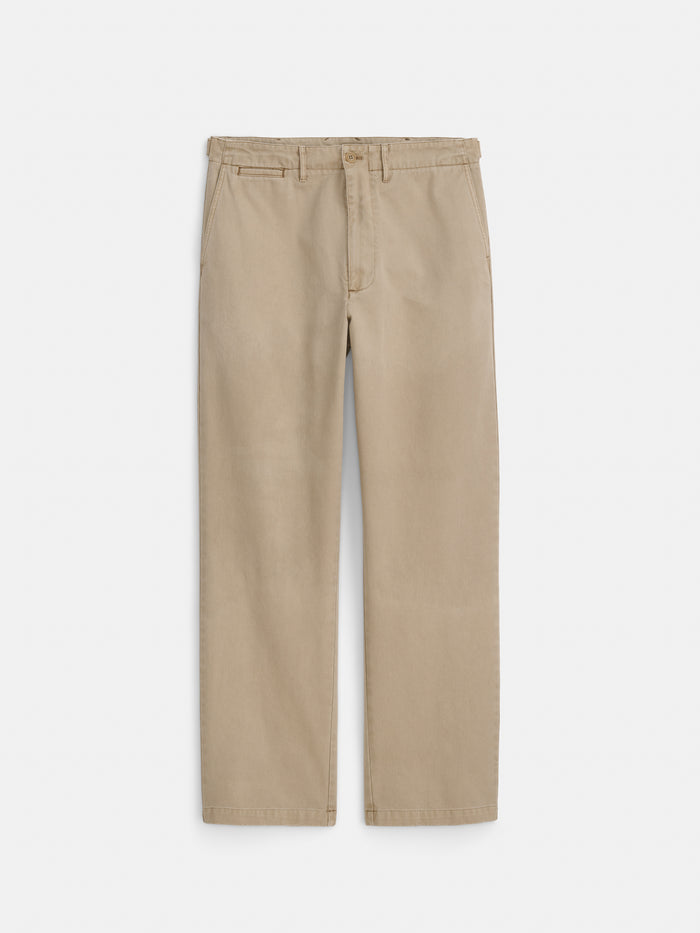 A pair of Flat Front Chino in Vintage Wash, featuring a beige garment-dyed fabric with a straight leg cut, button and zipper closure, belt loops, and side pockets, laid flat on a white background.