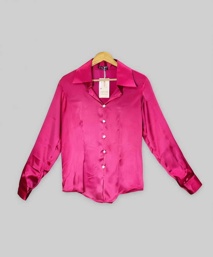 Pink satin shirt on a hanger against a red and white striped background