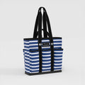 Blue and white striped tote bag with black handles on a light gray background